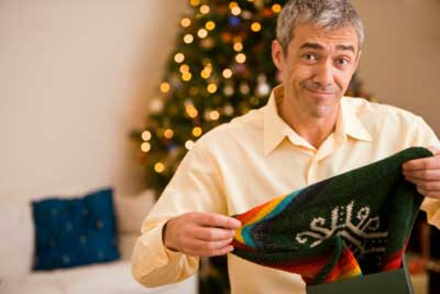 man holding ugly sweater