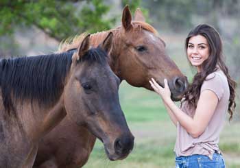 girl patting horse